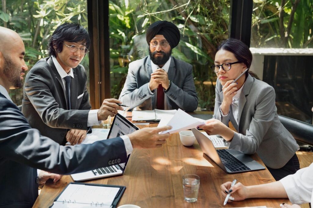 How to team lead a global team across continents and time zones photo of managers from across the world working together