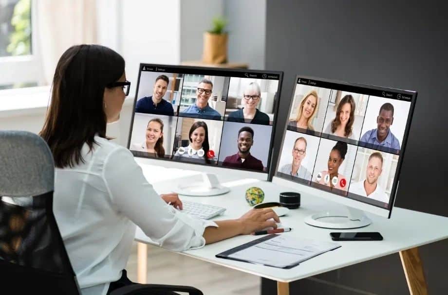 Practical tips to think about before a global video call showing a woman leader talking with many people on a video call