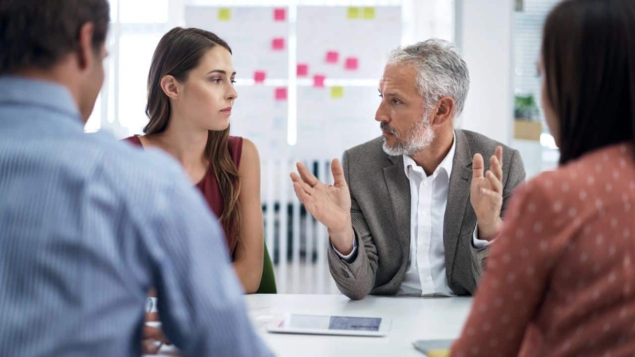 Making your global team inclusive picture of manager talking to team in meeting
